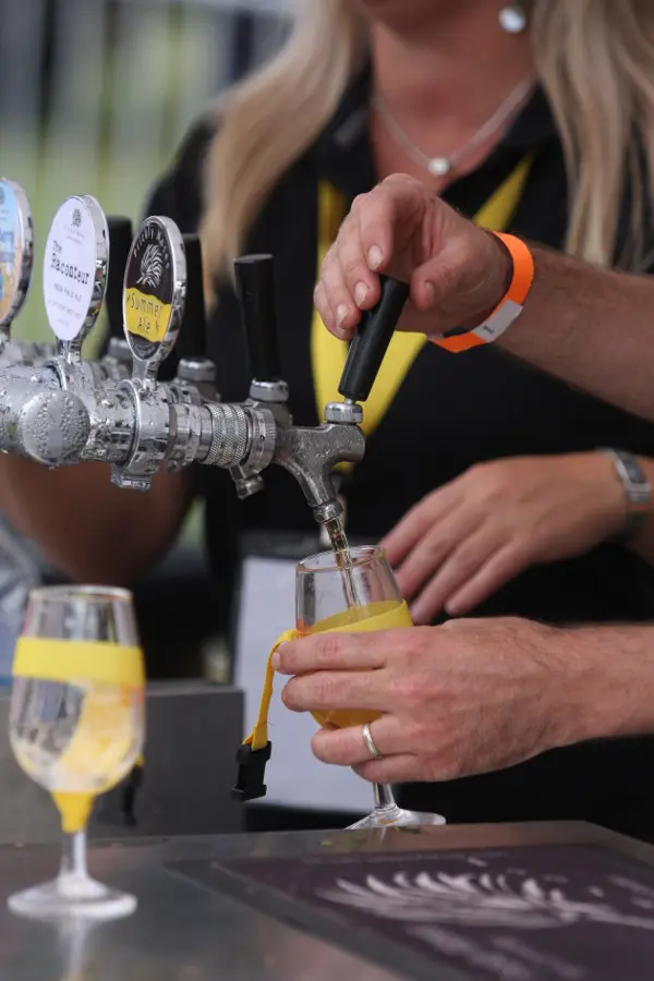 Hands pouring tastings of beer at the Ballarat Beer Festival
