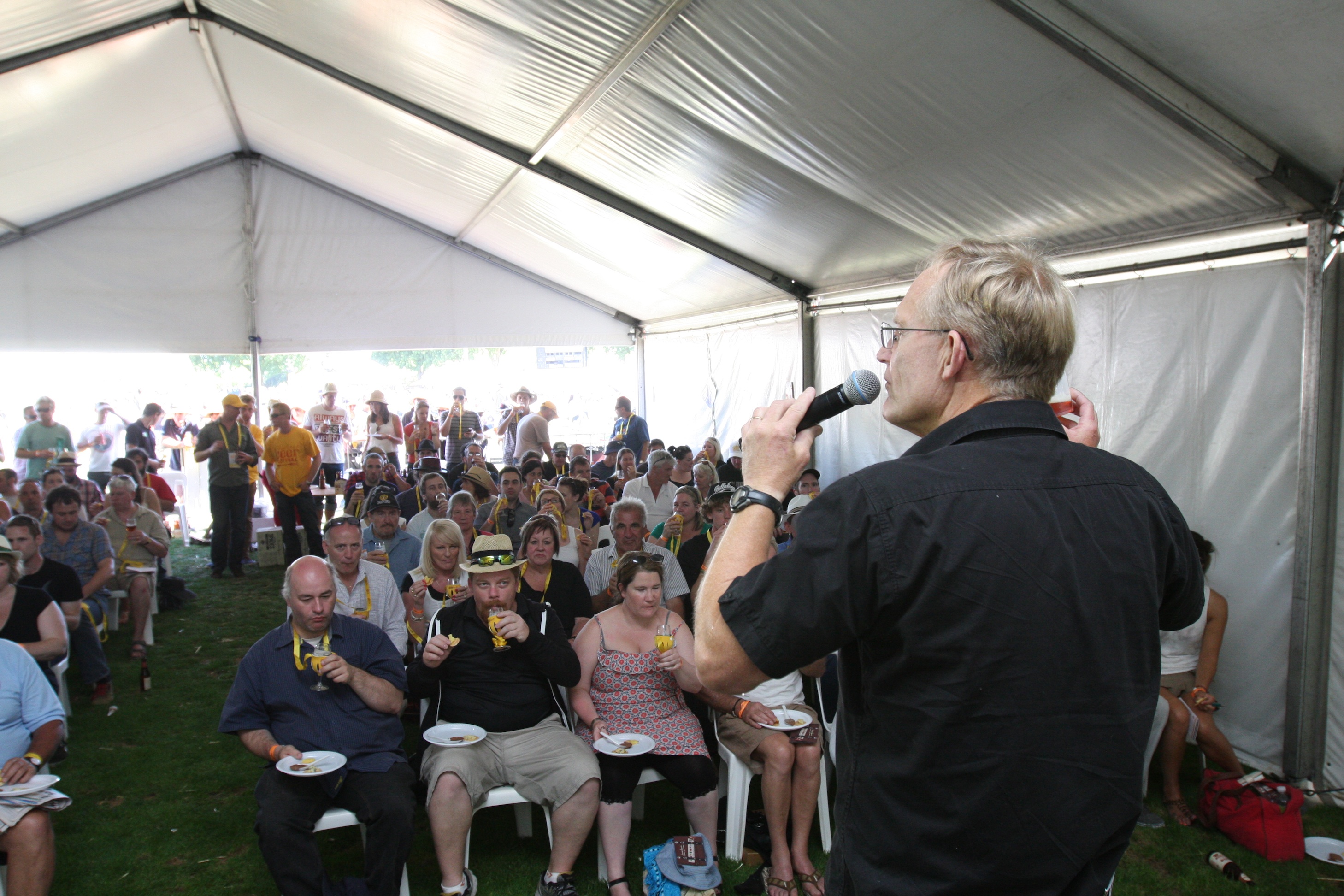 Chuck captures the crowd's attention with just a small plastic cup of James Squire Amber Ale.