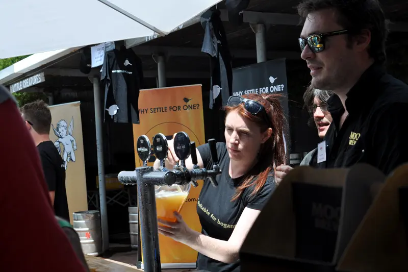 Staff pour Moo Brew beers at the festival