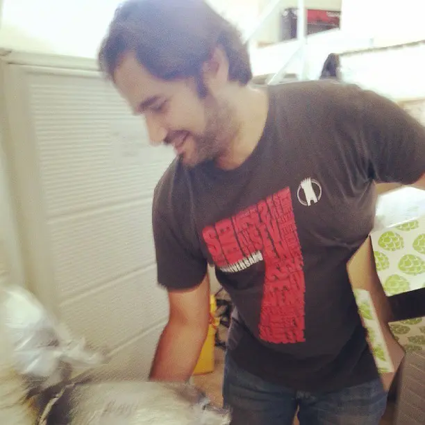 Leo Di Vicenzo pours hops into a brew.