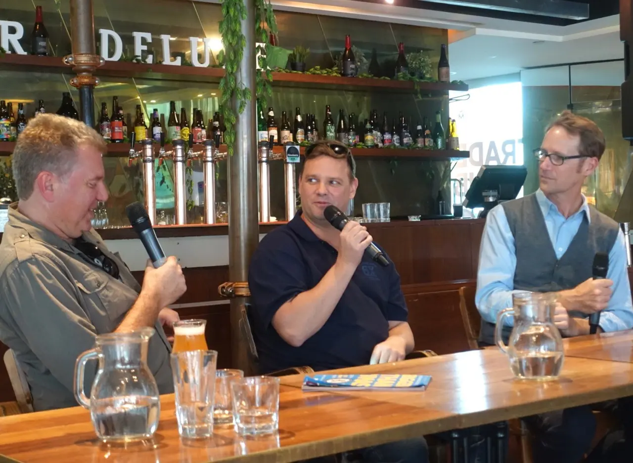 A browbeaten Brendan Varis (centre) with Radio Brews News' Pete Mitcham and Matt Kirkegard