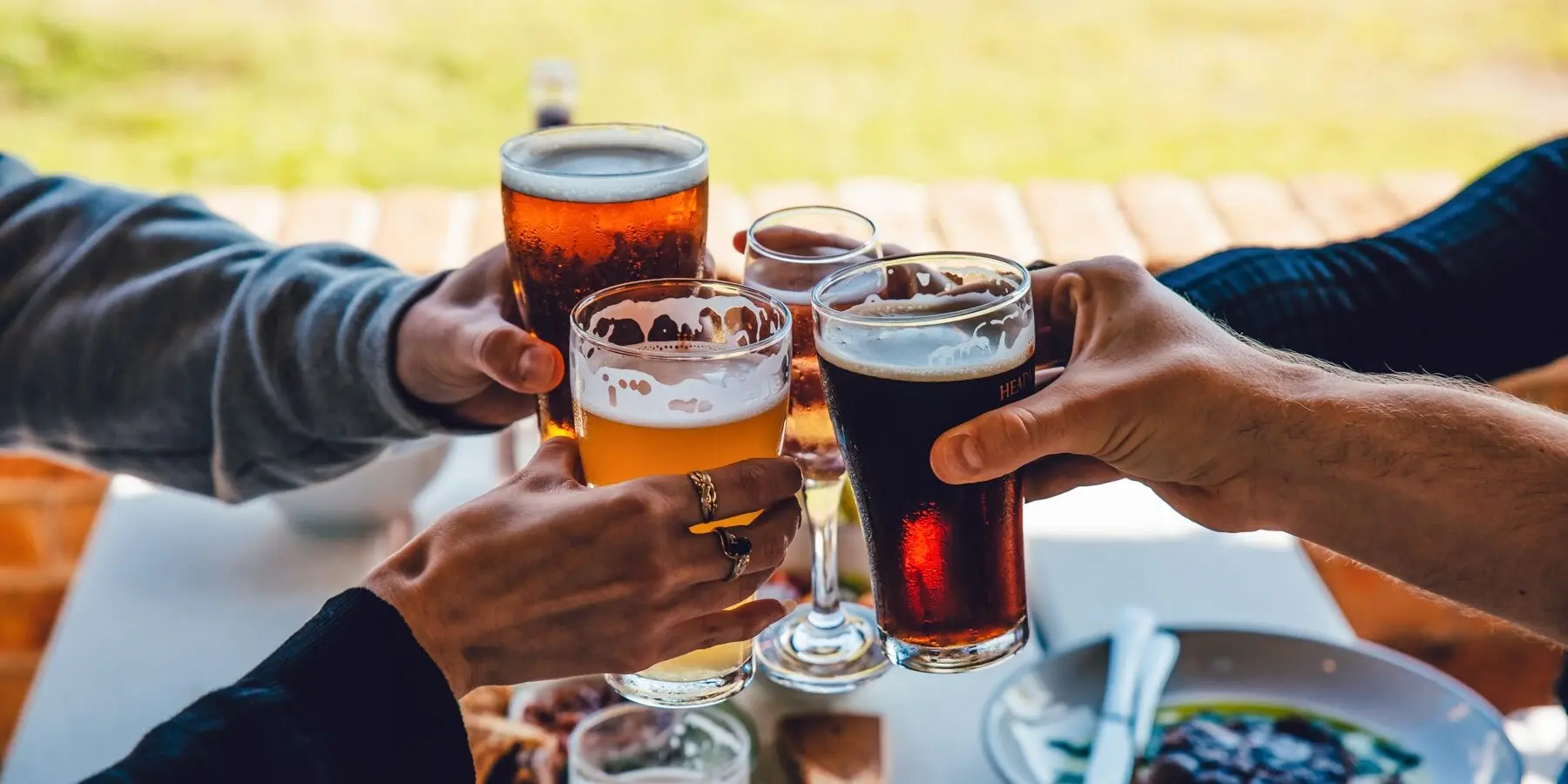 People holding beer glasses in a toast