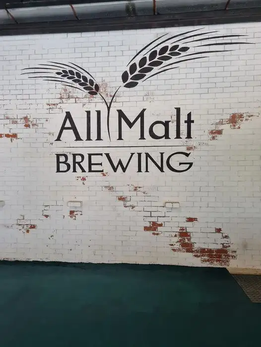 Wall that displays the All Malt Brewing logo