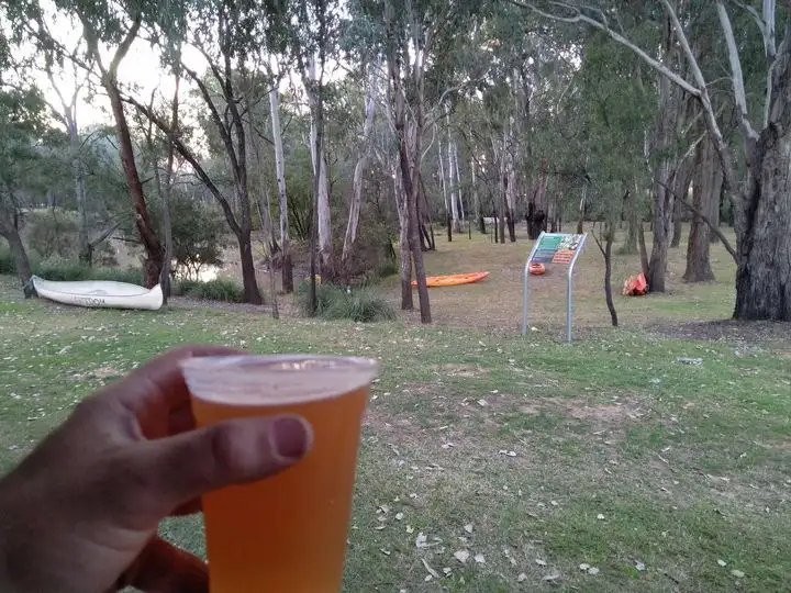 Hand holding a beer at the site of Charleys Creek Brewing in Chincilla