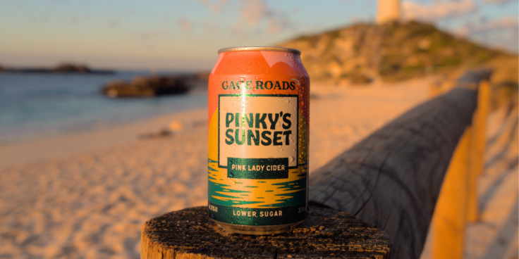 Can of Pinky's Sunset by Gage Roads Brew Co with beach in the background