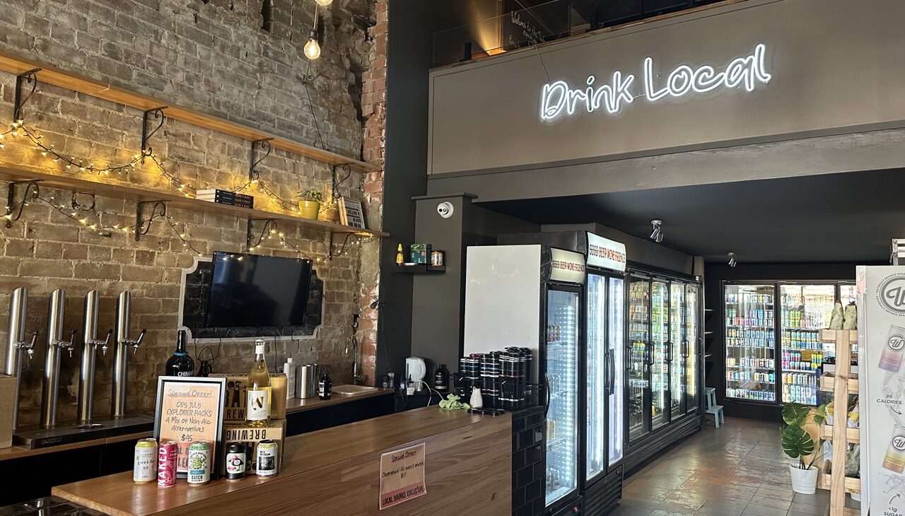 Interior of Local Drinks Collective's small bar and bottle shop that is for sale