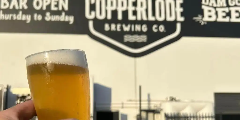 Beer being held in front of Copperlode Brewing Co venue