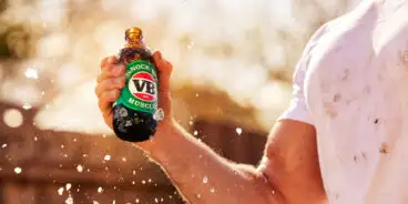 Man holding a Victoria Bitter bottle