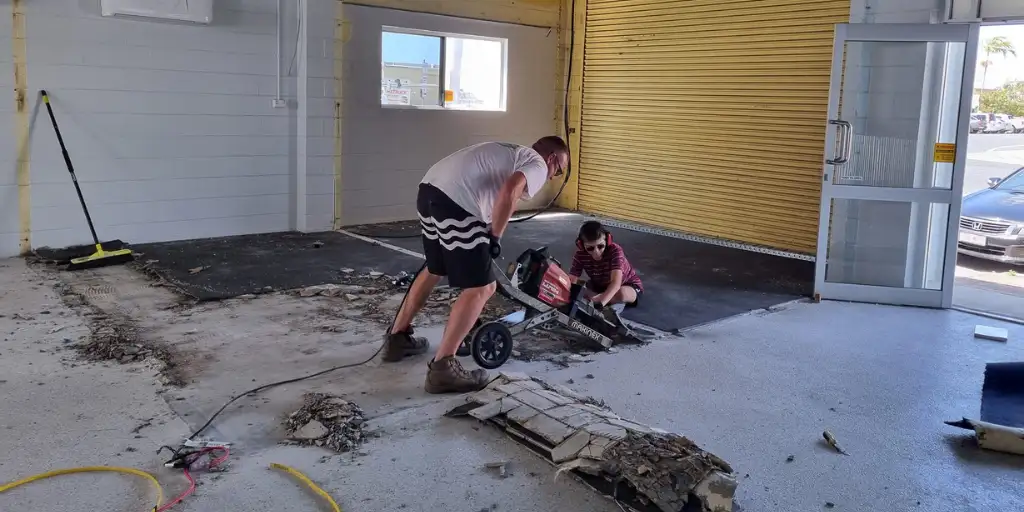 Workers grinding the floors at Goanna Brewing