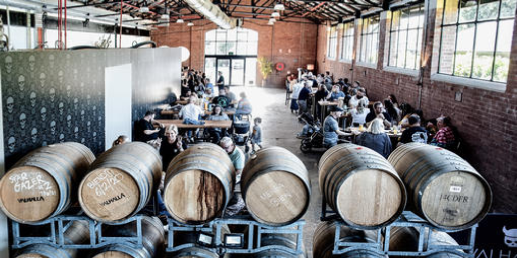 High angle shot of barrel and people seated at Valhalla Brewing